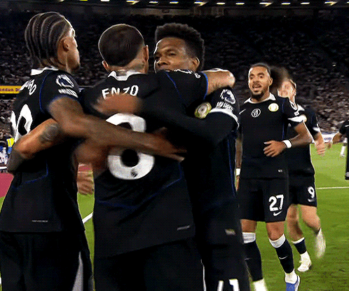 Soccer Players Including Number 27 Hugging