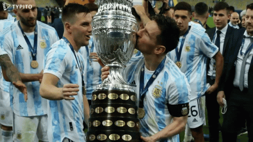 Soccer Players Kissing A Trophy With The Number 6 On Their Shirt GIF