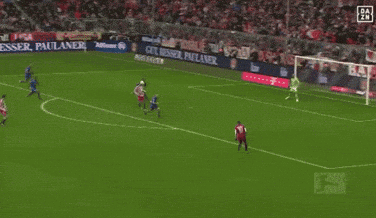 soccer players on a field with a banner that says paulaner on it