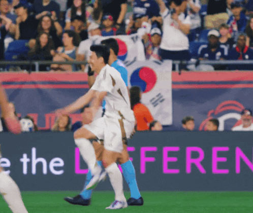 Soccer Players On A Field With A Banner That Says The Difference GIF
