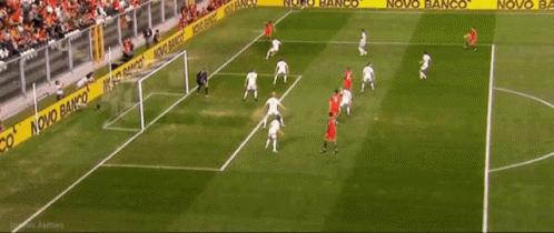 Soccer Players On A Field With A Novo Banco Banner Behind Them GIF