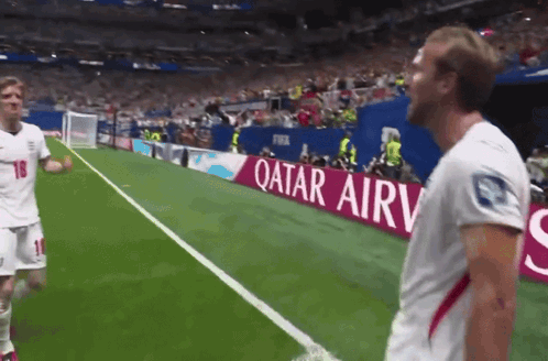 Soccer Players On A Field With A Qatar Airv Banner GIF