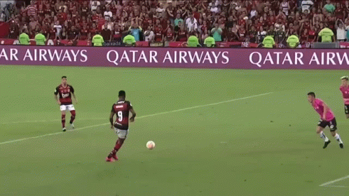Soccer Players On A Field With A Qatar Airways Banner In The Background GIF