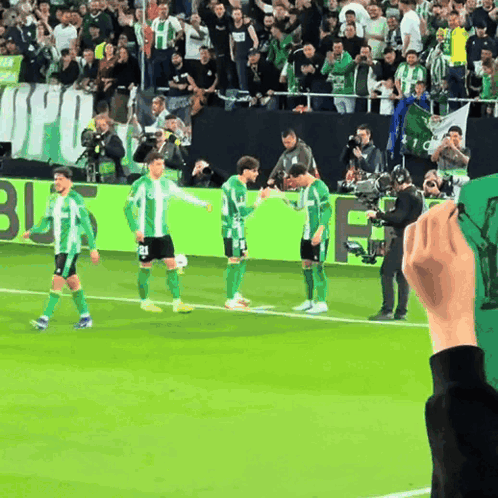 Soccer Players on Field With Banner Saying Jfu