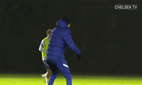 Soccer Players on Field With Chelsea TV