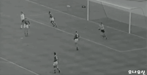 Soccer Players on Field with Chinese Writing