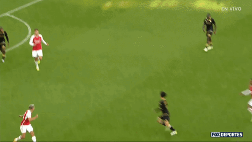 Soccer Players on Field with En Vivo