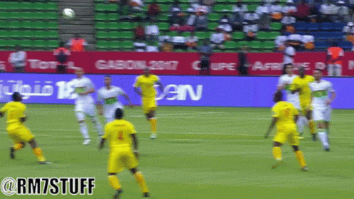 Soccer Players on Field with Gasoline Sign