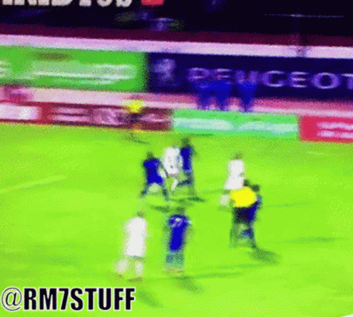 Soccer Players on Field with Peugeot Ads