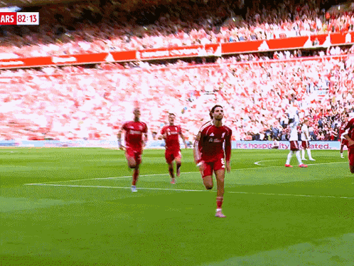 Soccer Players on Field With Sign Ars 82:13
