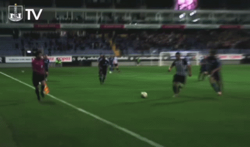 Soccer Players on Field with TV