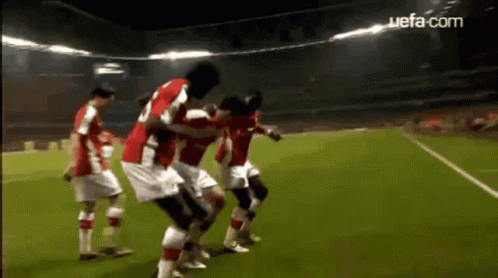 Soccer Players on Field with UEFA.com