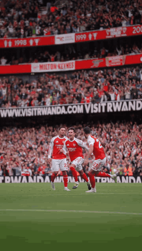 Soccer Players on Field With Visitwanda.com Banner