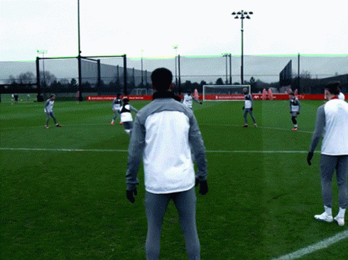 Soccer Players Playing on Field with Coca Cola Banner