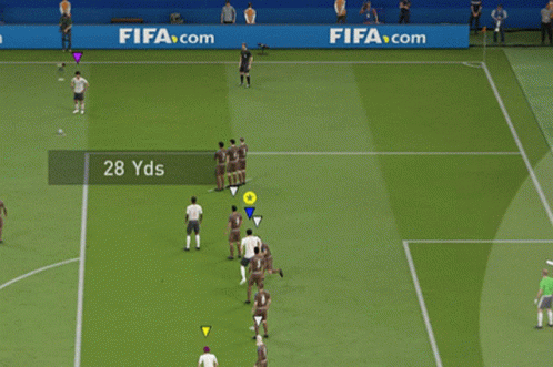 Soccer Players Playing on Field With FIFA Banner