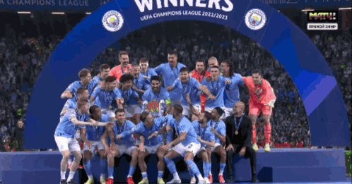 Soccer Players Posing Under Champions League Banner