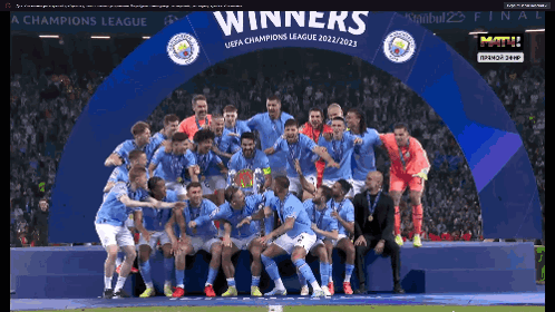 Soccer Players Posing Under Winners Banner