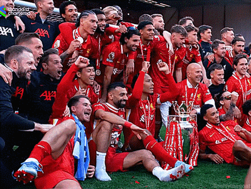 Soccer Players Posing With Trophy and Standard Chartered Shirt