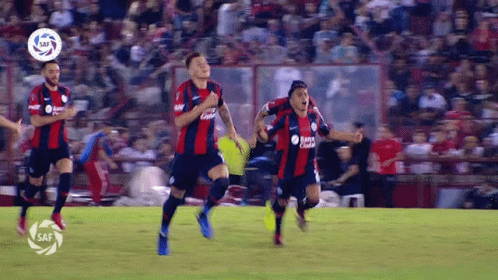 Soccer Players Running Banco Central Shirt