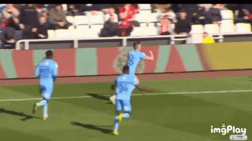 Soccer Players Running on Field
