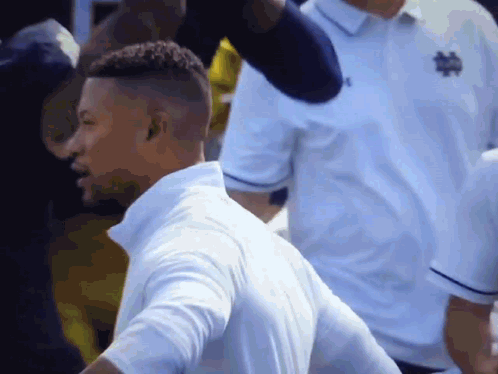 Soccer Players Running on Field In Front of Crowd
