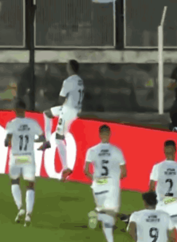 Soccer Players Running on Field Number 9