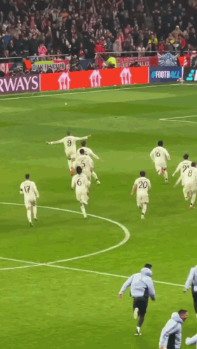 Soccer Players Running With Airways Banner