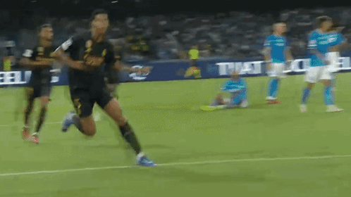 Soccer Players Running with TNT Sign