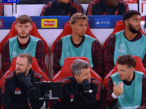 Soccer Players Sitting In Stadium With Walkers And PS5 Logos GIF