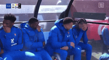 Soccer Players Sitting on Bench With 'Anne' Shirt