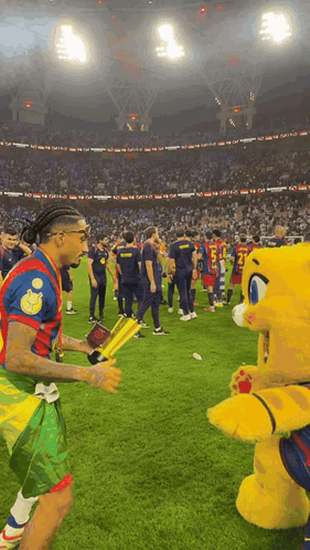 Soccer Players Standing With Mascot