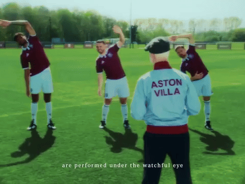 Soccer Players Stretching with Man in Aston Villa Jacket
