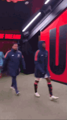 Soccer Players Walking Past Theatre of Dreams