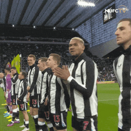 Soccer Players Wearing Black and White Striped Jerseys
