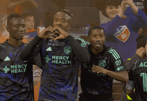 Soccer Players Wearing Mercy Health Jerseys Are Celebrating A Goal GIF