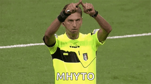 Soccer Referee in Yellow Shirt Making Heart Shape