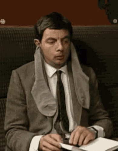 Socks On Ears Mr Bean Waiting And Reading GIF