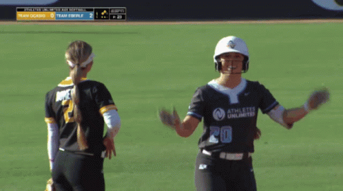 Softball Player Number 20 Celebrating With Teammate