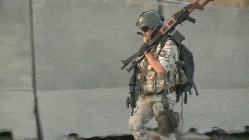 Soldier Carrying Gun Number 23 on Back