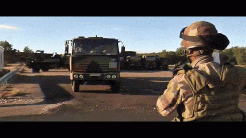 Soldier in Front of Military Truck with LC License Plate