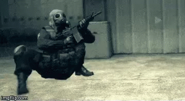 Soldier in Gas Mask Holding Gun in Building