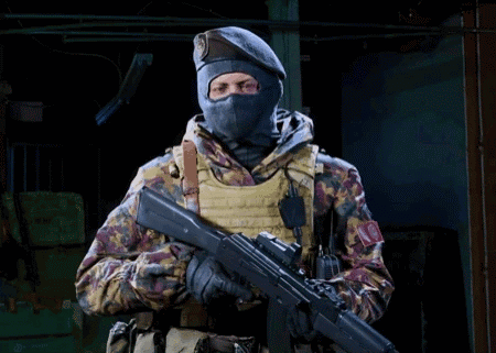 Soldier in Mask and Beret Holding Rifle