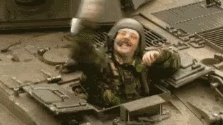 Soldier Sitting on Tank With Helmet