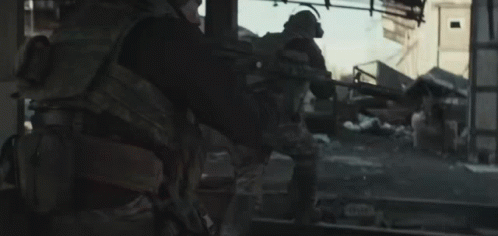 Soldier Walking Through Destroyed City With Gun