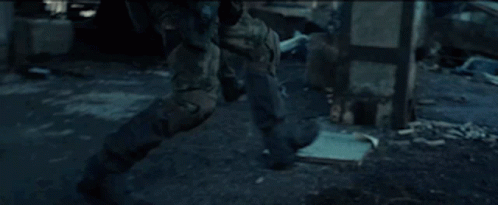 Soldier Walking Through Ruined Building With Gun