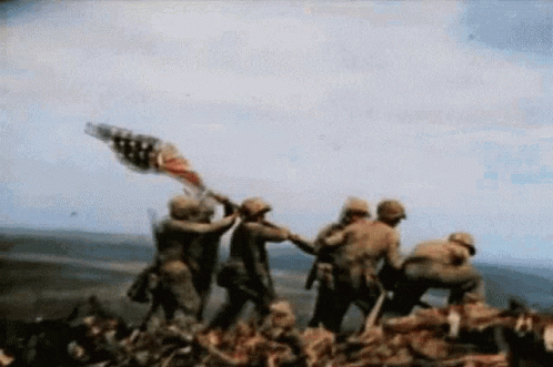 Soldiers Holding American Flag on Hill