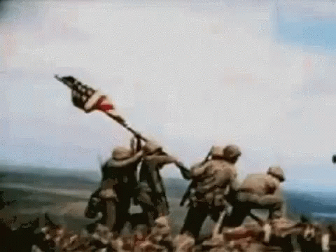 Soldiers Holding American Flag on Hill