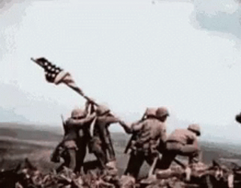 Soldiers Holding American Flag on Mountain