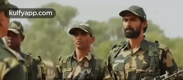 Soldiers Holding Guns in Field