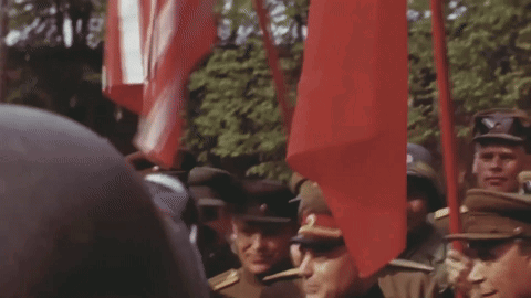 Soldiers Holding Red Flags GIF